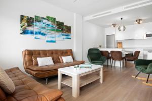 sala de estar con sofá y mesa en Stunning flat with pool and padel in Wellingtonia M4, en Estepona