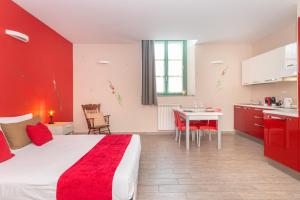 a hotel room with a large bed and a table at Housing Giulia in Turin
