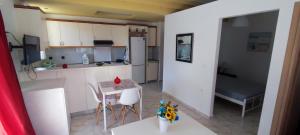 a small kitchen with a table and chairs and a bed at Chania City Apartments in Chania