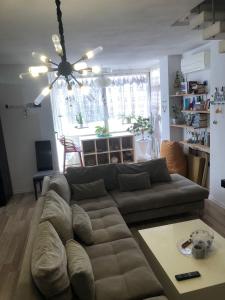 a living room with a couch and a table at 2 bedroom duplex Durrës in Durrës