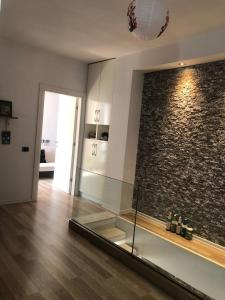 a room with a glass wall and a brick wall at 2 bedroom duplex Durrës in Durrës