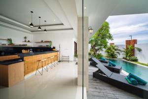 an open kitchen and living room with a swimming pool at Selina - PROMO- Berawa - 3 BDR - Brand NEW Villa - HUGE Pool in Canggu