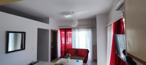 a living room with a chair and a window at Chania City Apartments in Chania