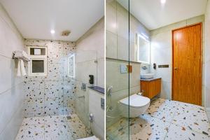 two pictures of a bathroom with a toilet and a shower at FabHotel Soft Petals in Gurgaon