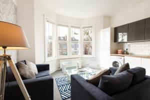 a living room with a couch and a table at Stunning 5-Bed Maisonette in Bristol in Bristol