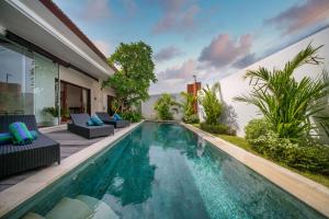 a swimming pool in the backyard of a villa at Selina - PROMO- Berawa - 3 BDR - Brand NEW Villa - HUGE Pool in Canggu