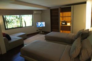 a living room with a couch and a flat screen tv at Petitenget 501 in Seminyak