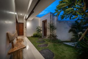 a garden in the middle of a house at Selina - PROMO- Berawa - 3 BDR - Brand NEW Villa - HUGE Pool in Canggu