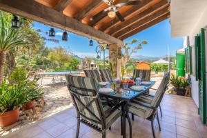 an outdoor dining room with a table and chairs at Finca JESUS Pollensa in Port de Pollensa