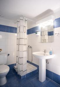 a bathroom with a sink and a toilet and a shower at DOMES APARTMENTS in Kallithea Halkidikis