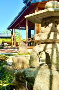 a stone fountain in front of a building at Private Villa ietona in Fujikawaguchiko