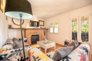 a living room with two couches and a fireplace at Finca JESUS Pollensa in Port de Pollensa