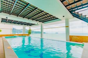 an indoor swimming pool with a view of the water at Nha Trang Wonderland Hotel in Nha Trang
