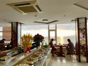 a buffet line with plates of food in a restaurant at Nha Trang Wonderland Hotel in Nha Trang