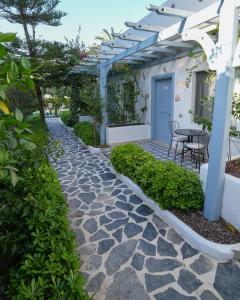 a patio with a table and a white pergola at Kassandra Boutique Hotel in Oludeniz