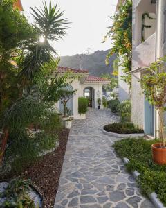 a garden with a stone walkway in a house at Kassandra Boutique Hotel in Oludeniz