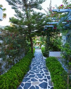 a stone path with a tree in the middle at Kassandra Boutique Hotel in Oludeniz