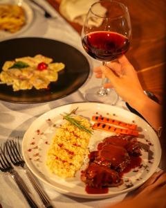 a table with a plate of food and a glass of wine at Kassandra Boutique Hotel in Oludeniz