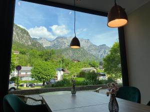 a table with a view of mountains from a window at Pension und Ferienwohnung Frech in Marktschellenberg