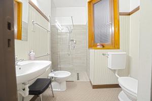 La salle de bains est pourvue d'un lavabo, de toilettes et d'une douche. dans l'établissement Grand Hotel SIVA - Adults Only, à Santo Stefano dʼAveto