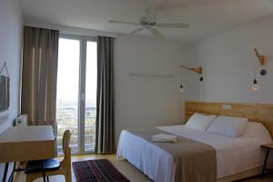 a hotel room with a bed and a large window at Narköy Ecologic Hotel & Organic Farm in Kocaeli
