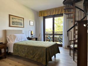 a bedroom with a bed and a large window at Grand Hotel SIVA - Adults Only in Santo Stefano dʼAveto