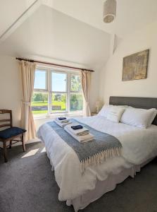 a bedroom with a large bed and a window at Humphries Cross Apartments in Rye