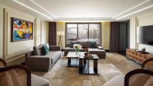 a living room with couches and a tv at UrCove by Hyatt Beijing Guomao Sanlitun in Beijing
