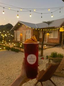 a person holding a cup with a banana in it at Retro House Mộc Châu in Mộc Châu