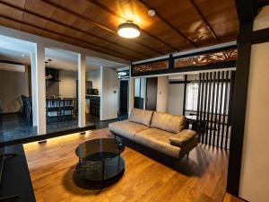 een woonkamer met een bank en een tafel bij Izumo Biyori Horikawa Villa - Vacation STAY 28459v in Izumo