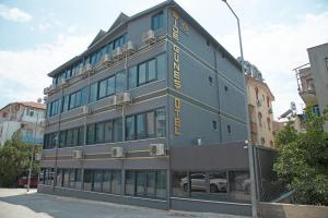 a blue building with yellow writing on the side of it at Side Güneş Otel in Side