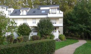 a large white house with a pathway in front of it at Gîte Des Vergers in Illkirch-Graffenstaden