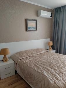 A bed or beds in a room at Macon Residence Apartments in Saint Vlas