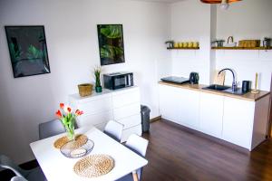 a small kitchen with a table and a microwave at Srokówka Resort in Dąbrówka