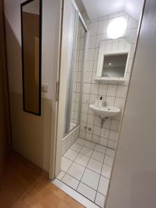 a bathroom with a shower and a sink and a mirror at Einzelzimmer (16) in Meine