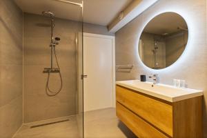 a bathroom with a sink and a shower at Midtown Hotel Royal Room in Amsterdam