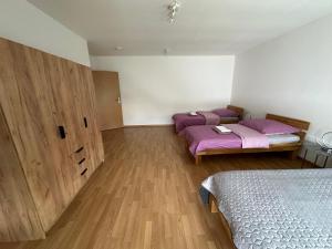 a bedroom with two beds with purple sheets on them at Großes Apartment im DG in Leipzig