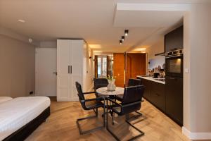 a kitchen and dining room with a table and chairs at Midtown Hotel Royal Room in Amsterdam