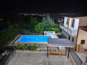 a swimming pool on a balcony of a house at APEX Rest house of 10 rooms and pool in Yerevan