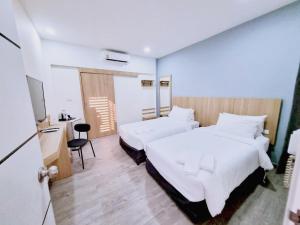Postel nebo postele na pokoji v ubytování Beyond 21 Hotel