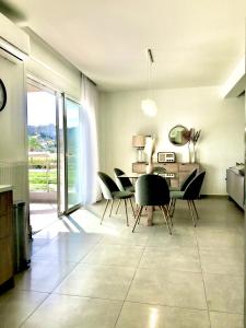 a dining room with chairs and a table with a desk at Koroni House in Heraklio