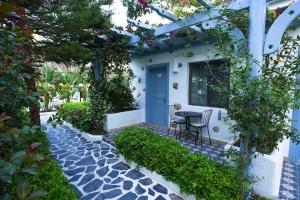 a house with a blue door and a table and chairs at Kassandra Boutique Hotel in Oludeniz