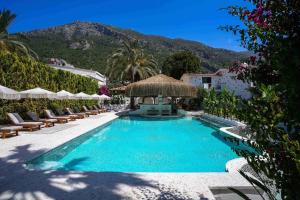 a swimming pool with lounge chairs and a resort at Kassandra Boutique Hotel in Oludeniz