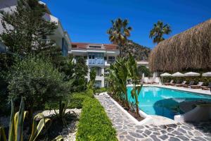 a resort with a swimming pool and a building at Kassandra Boutique Hotel in Oludeniz