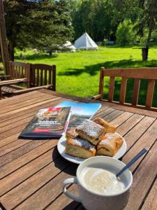 a table with a plate of bread and a cup of soup at Trapani house & camp in Růžová