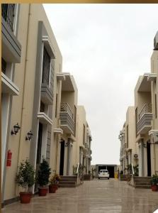 a car parked in a parking lot between two buildings at Xefan Hotels in Karachi