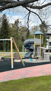 a playground with a slide and a slideintend at AC seaside apartments Albatross in Ķesterciems