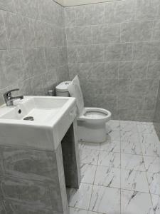 a bathroom with a sink and a toilet at Simple Homestay Balangan in Jimbaran +22 photos