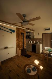 a living room with a ceiling fan and a kitchen at Seahorse apartment in Liepāja +5 photos
