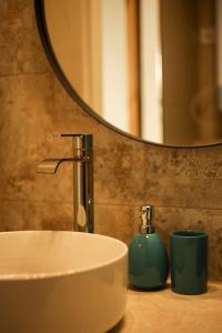 a bathroom sink with a faucet and a mirror at Seahorse apartment in Liepāja